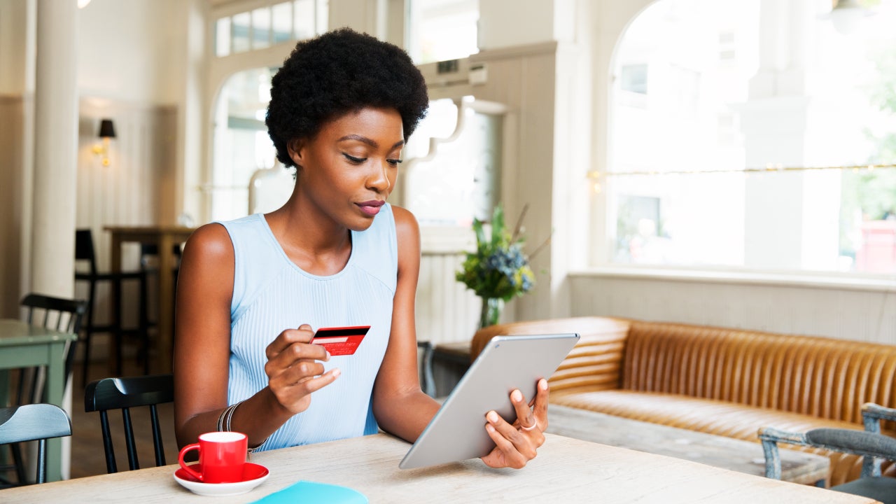 Woman with credit card and tablet