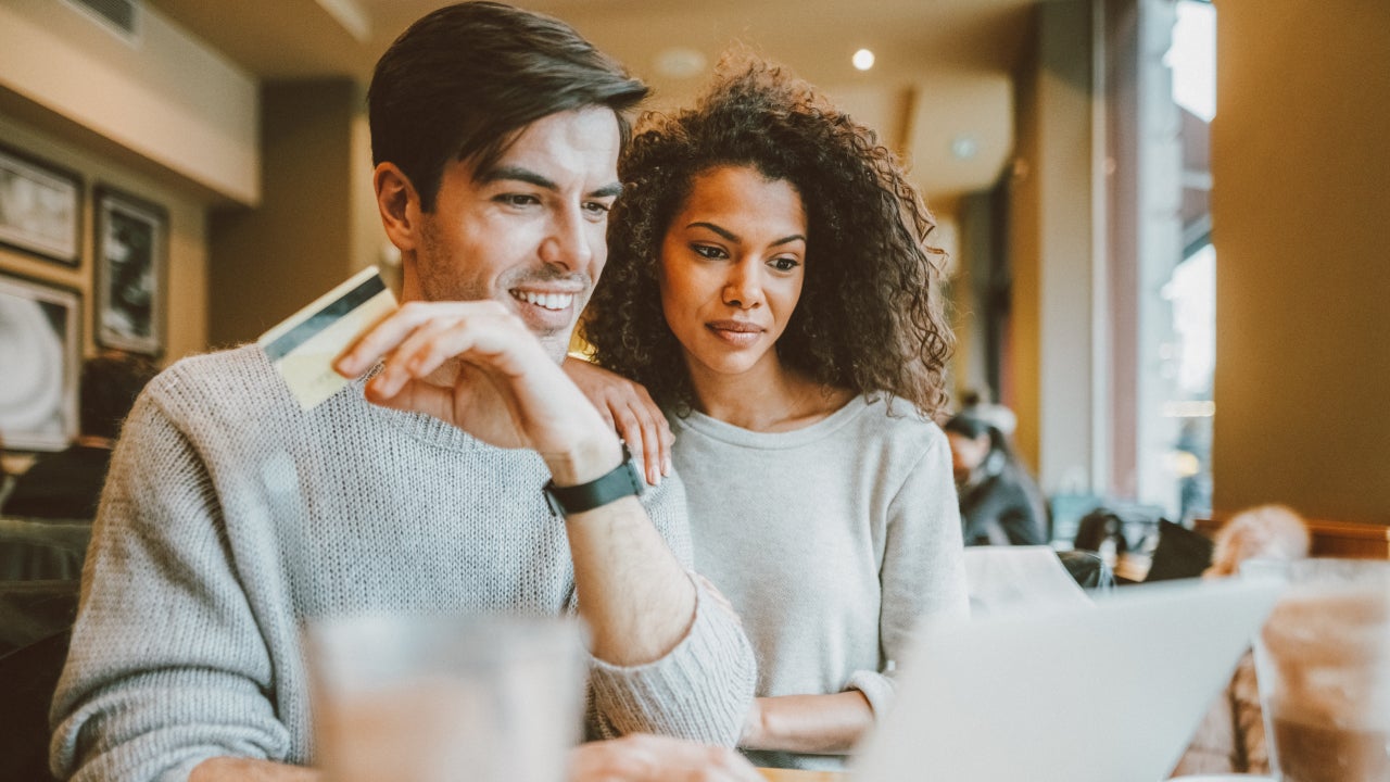 Couple in cafe shopping online