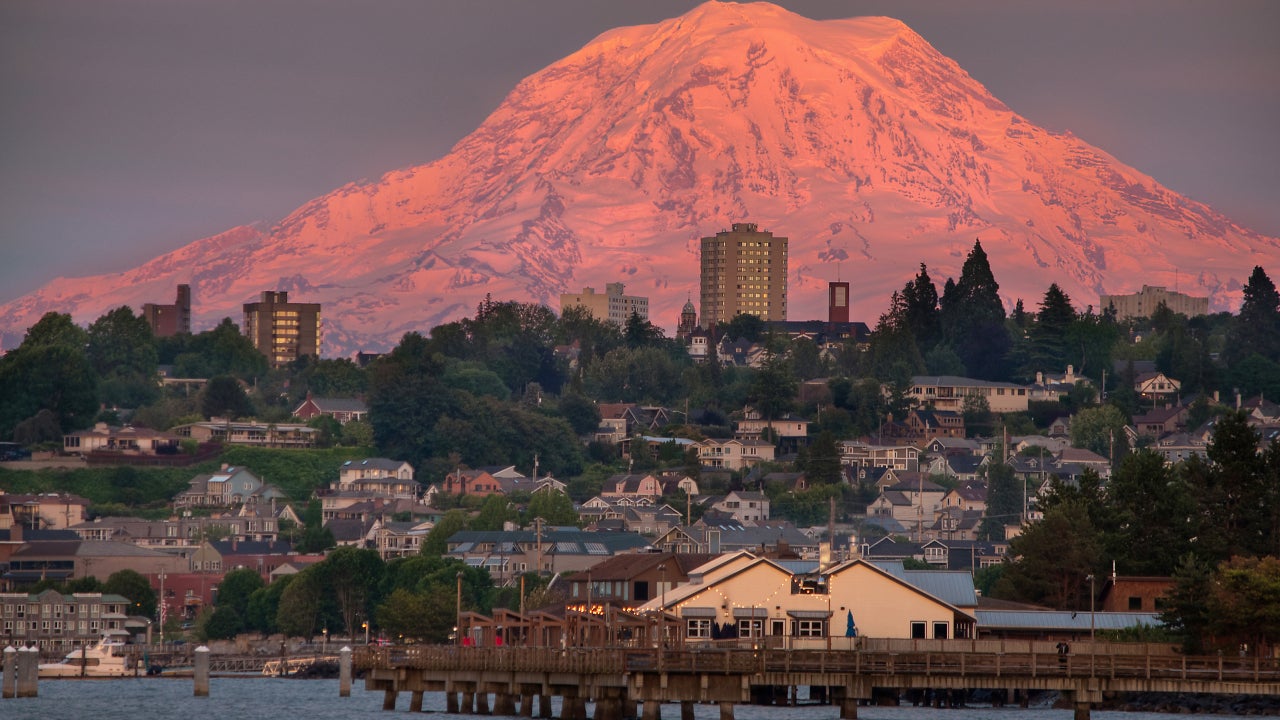 The famous Mount Rainier looms over Tacoma, WA at sunset