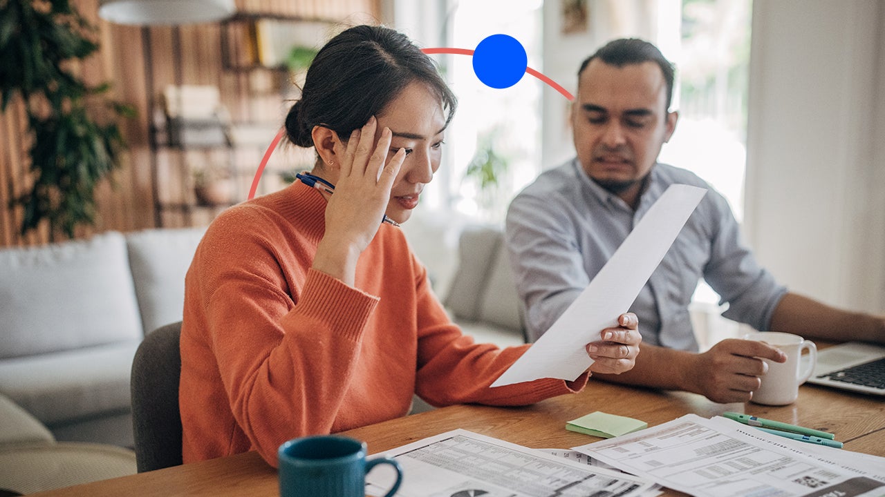 A couple reviewing documents, grimacing