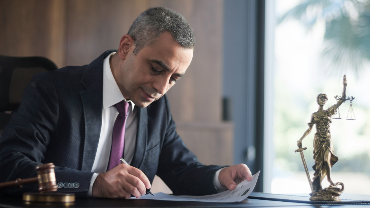 Judge or Legal advisor lawyer examining and signing legal documents.