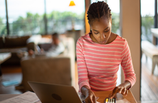 Woman doing taxes at her computer.