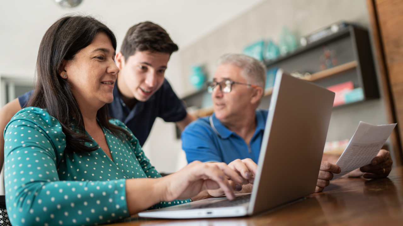 A couple and their teenaged son work together to file their taxes.