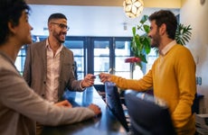 Businessman getting hotel room key card from reception