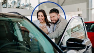 Couple looking at new car