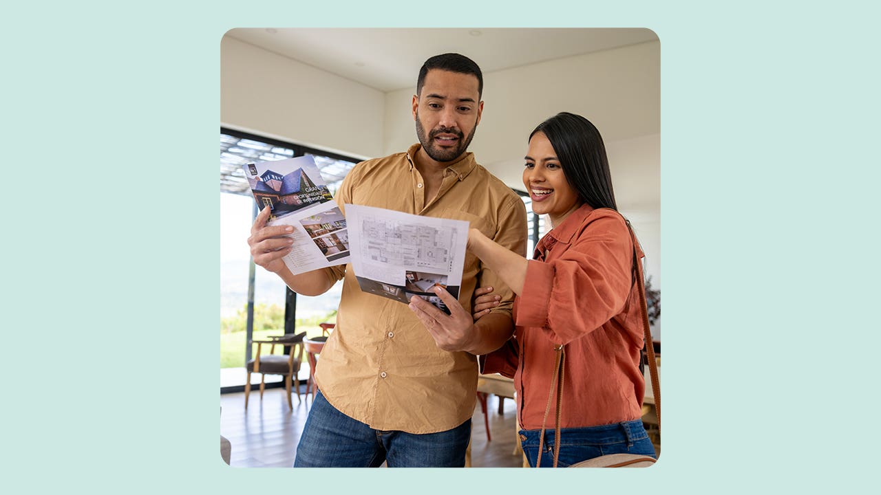 house-hunting couple looking at for-sale home listings together