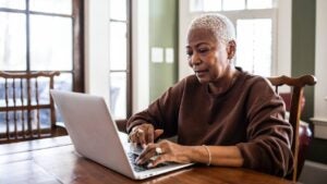 Senior woman using laptop at home