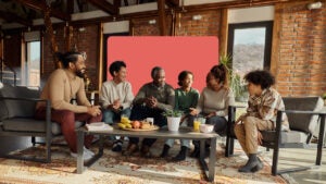 smiling multigenerational family sitting around a coffee table