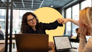 Two women giving a fist bump