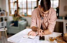 Young man going over financial statements in his apartment.