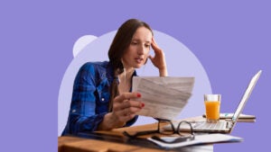 Woman studying various checks, money