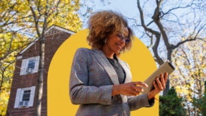 Realtor standing outside a home looking at paperwork