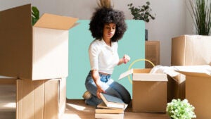 A woman unpacking books