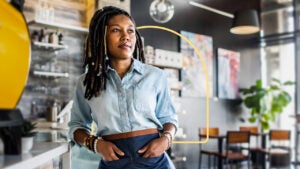 design image of a server with her hands in her pockets