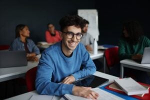 male student smiling in classroom