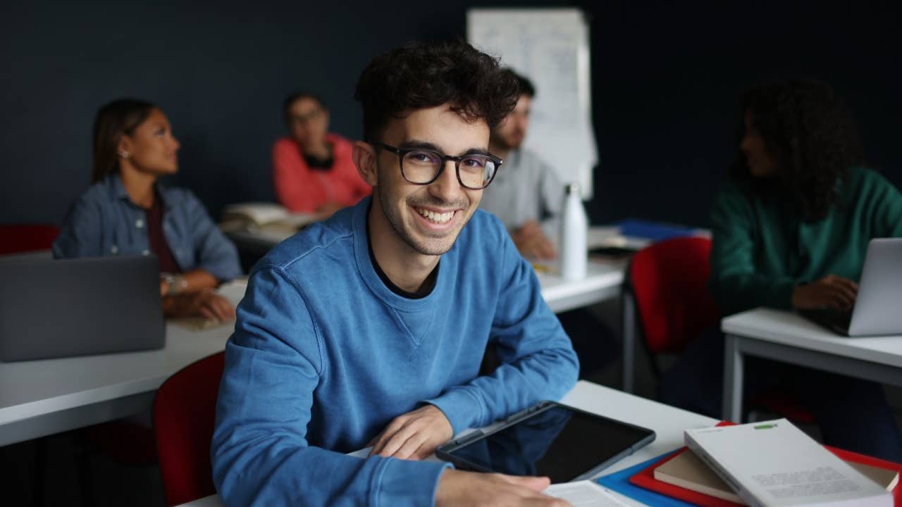 male student smiling in classroom