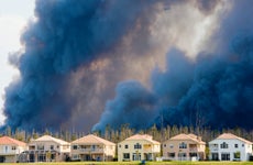 Houses against backdrop of smoke from wildfires