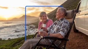 Older couple enjoying the beach as dawn breaks