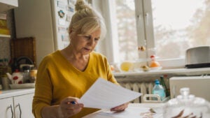 Senior woman filling out financial statements