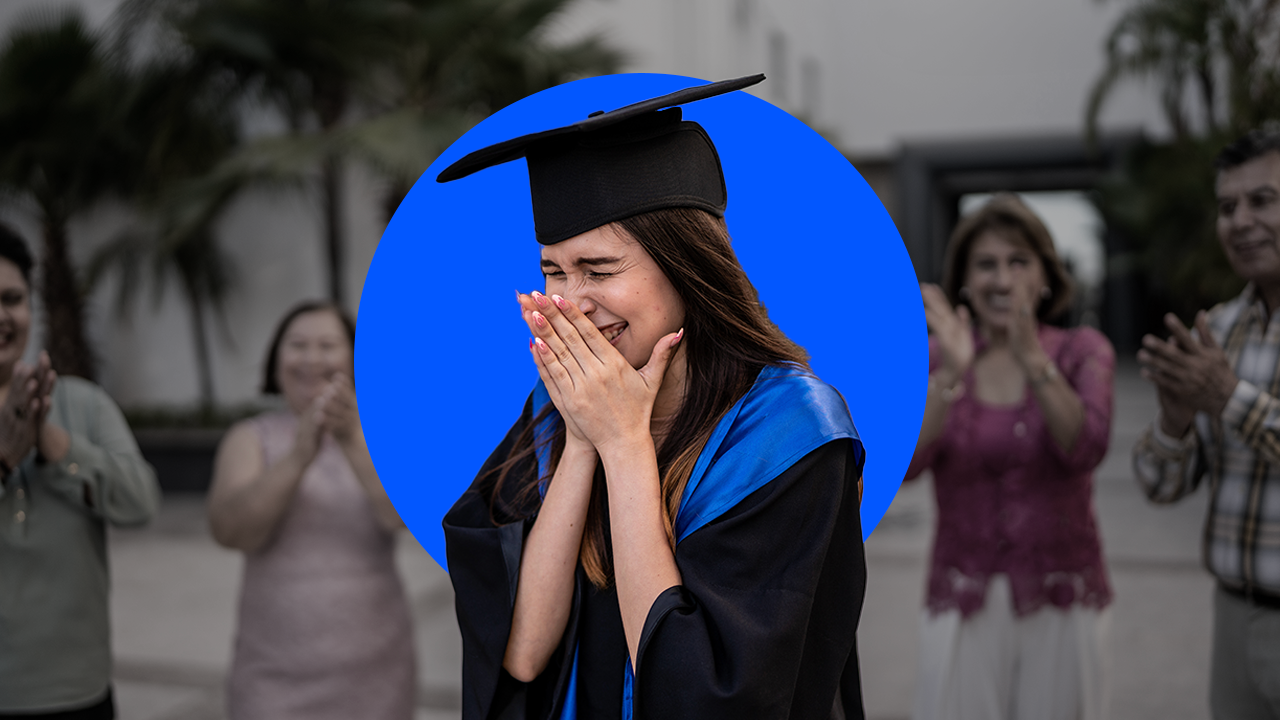 college graduate moved to tears as people clap in the background