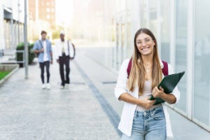 Blond college girl smiling, ready for classes at a university campus