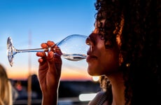 Woman is drinking champagne on a rooftop party