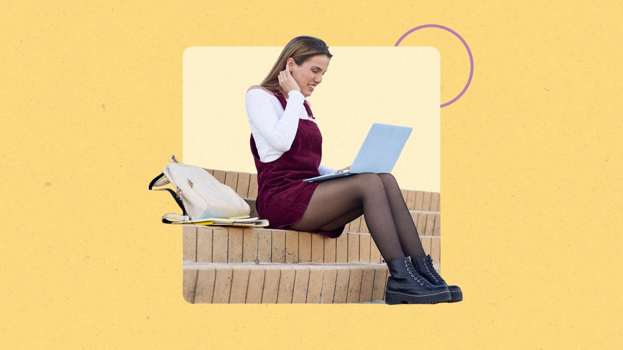 Young woman sitting outside on a laptop