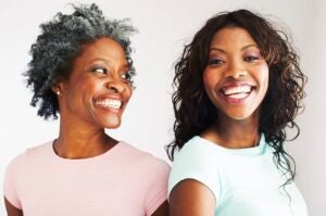 Black mother and daughter smiling happily