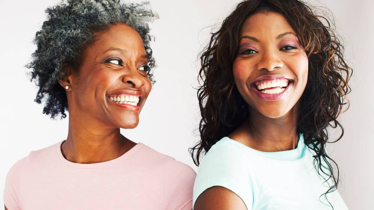 Black mother and daughter smiling happily