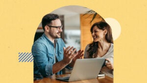 Two colleges discussing a work project around a laptop