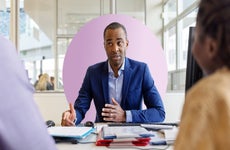 A consultant meets with a couple in his office.