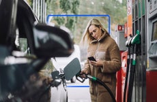 Woman paying at the gas pump