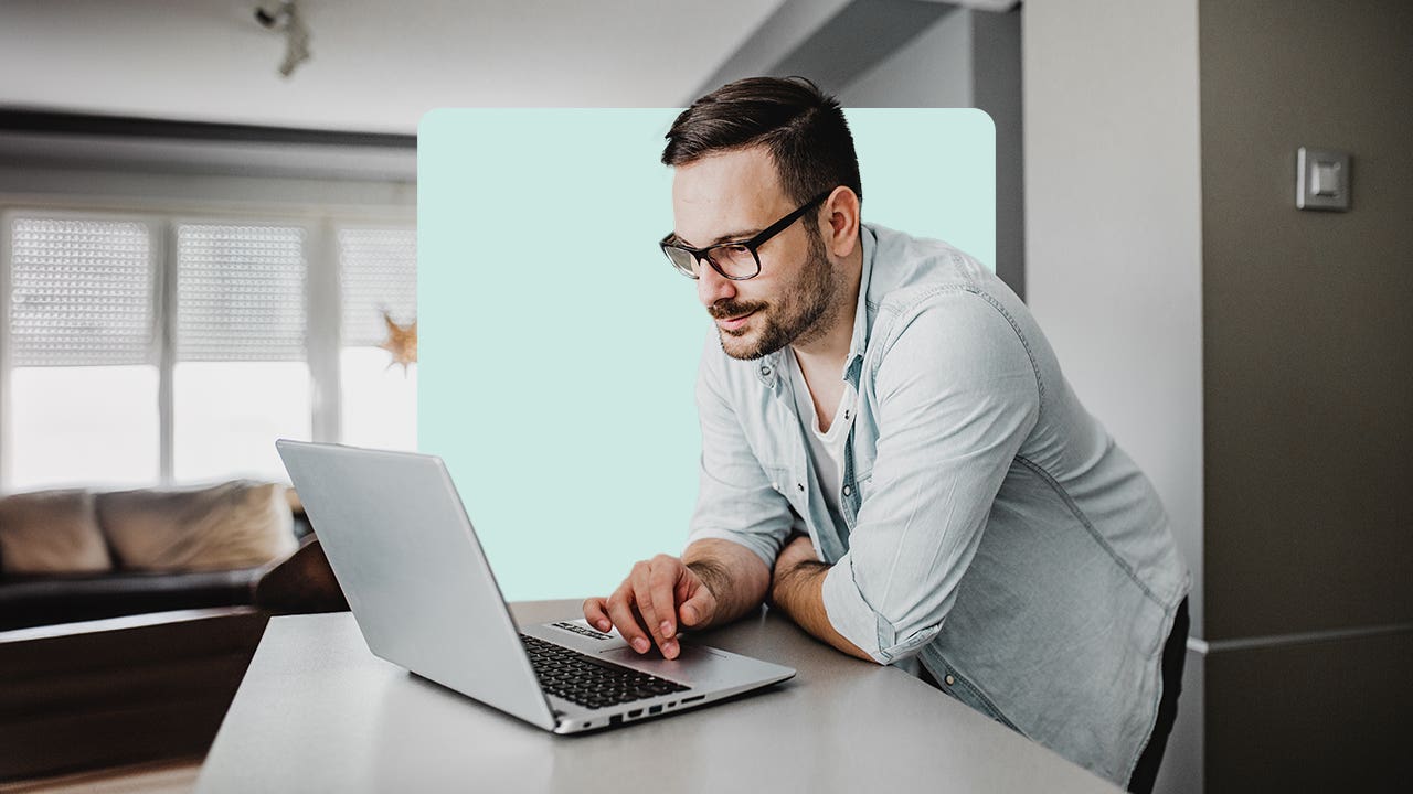 Man using laptop in kitchen