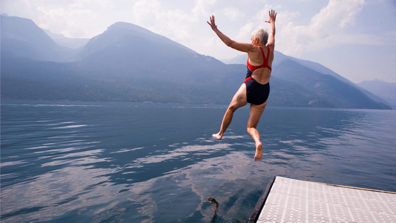 babyboomer jumping into lake