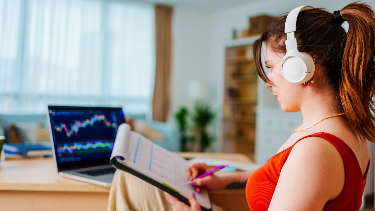 Young Businesswoman with Headphones checking Bitcoin or stock exchange