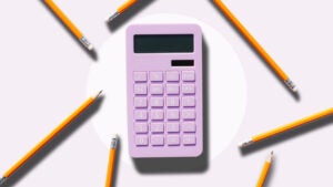 Pink calculator surrounded by pencils.