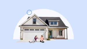 Two women sitting in front of an attached garage