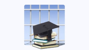 graduation cap on top of stack of books, all in front of a set of prison bars