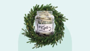 Evergreen wreath around a tip jar full of money