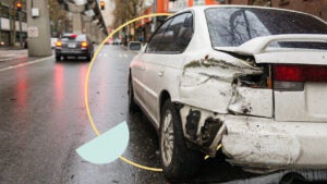 Car with a wrecked rear bumper in city street