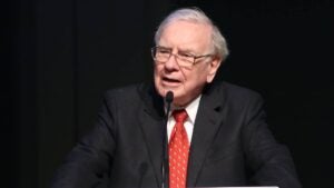 Warren Buffett speaks into a microphone.