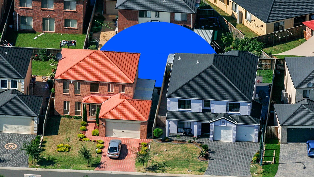 photo illustration aerial view of suburban homes with blue circle