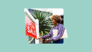 A real estate agent adjusting a for sale sign