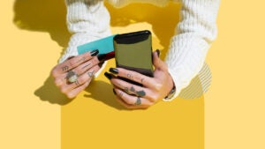 Design element of hands holding a phone and credit cards