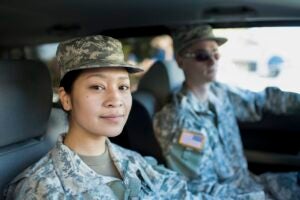 asian woman and white man in military uniform inside a car