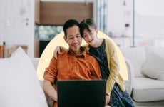 Child with parent looking at laptop