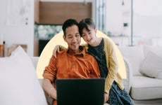 Child with parent looking at laptop