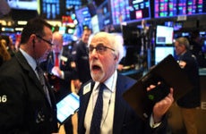 Traders work during the opening bell at the New York Stock Exchange