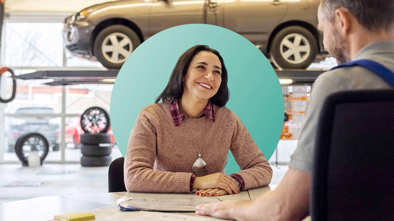 A woman in a car repair shop