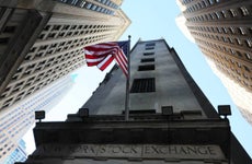 Exterior of the New York Stock Exchange as seen from the ground looking skyward.